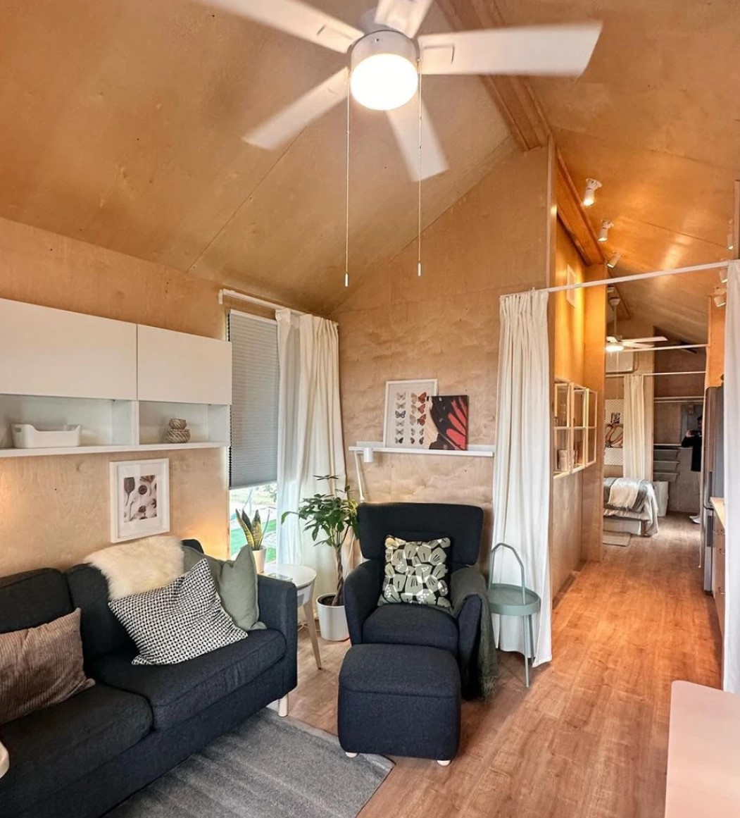Interior of the IKEA tiny house — open living area with modular curtains